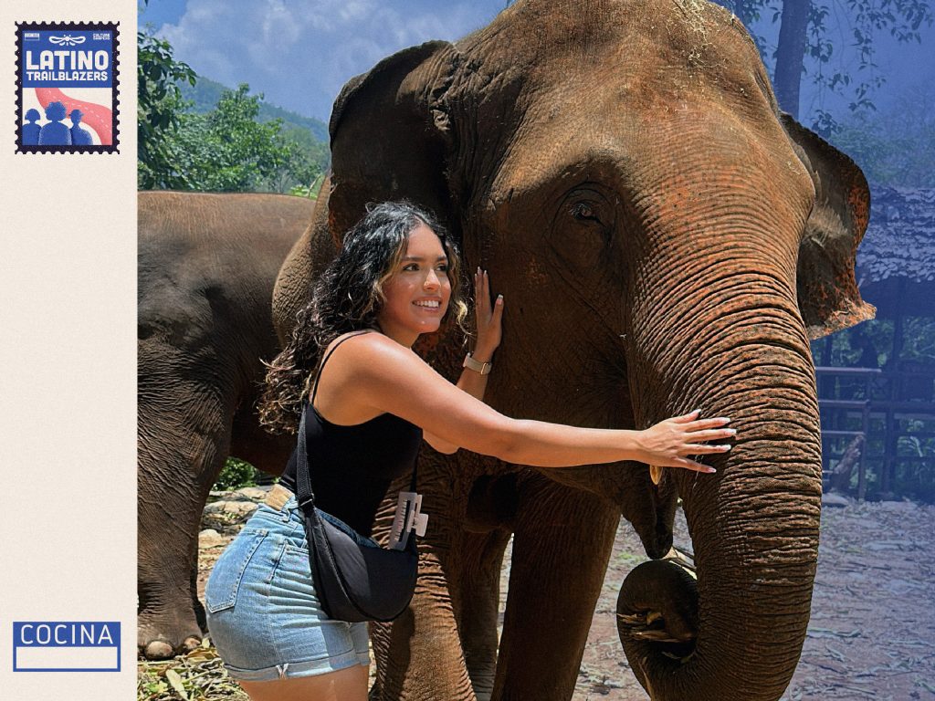 Henna Sharee, part of Latino Trailblazers, posing next to an elephant,