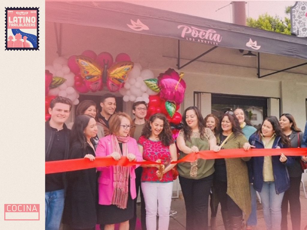 Claire Risoli, part of Latino Trailblazers, in the opening of her restaurant Pocha LA. She's cutting a red ribbon, joined by a multitude of people at the entrance of the building. Photo courtesy of Claire Risoli.