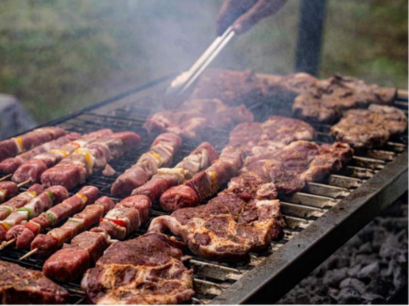 Somebody's always standing closest to the fire, and nobody else touches the meat.